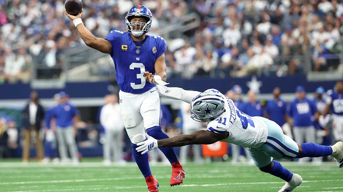 New York Giants quarterback Russell Wilson (3) passes the ball against Dallas Cowboys defensive end Donovan Ezeiruaku (41) during the third quarter at AT&T Stadium.