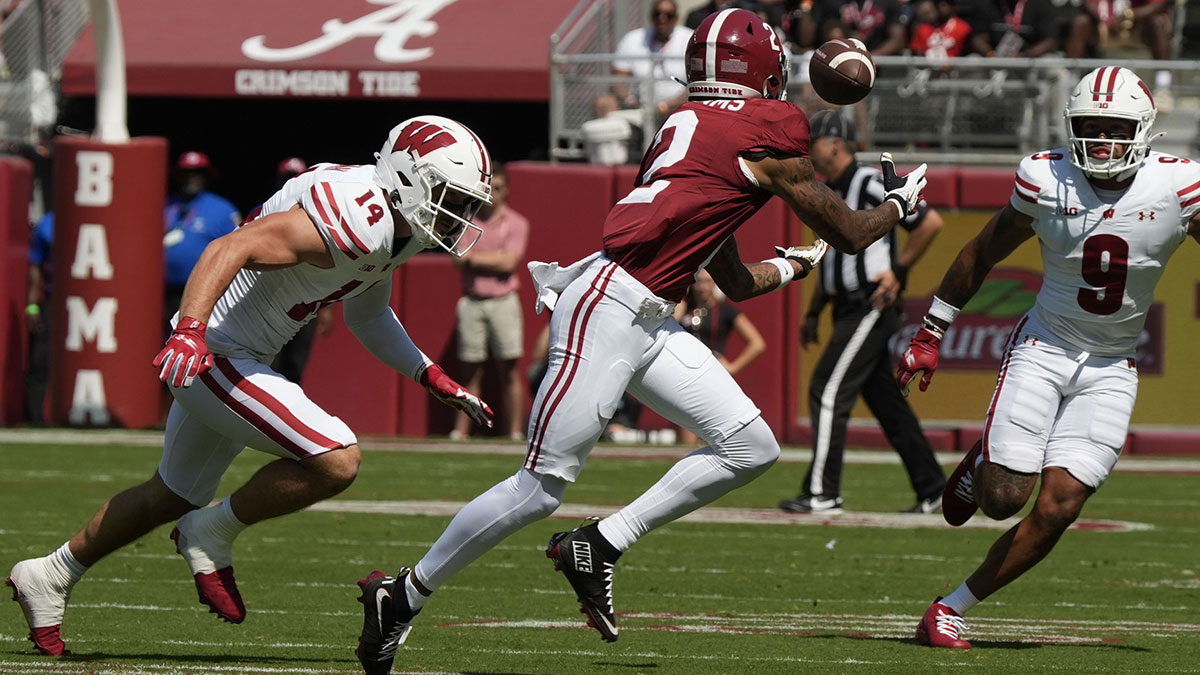 Alabama wide receiver Ryan Williams (2) makes a catch between Wisconsin defensive back Preston Zachman (14) and Wisconsin defensive back Austin Brown (9) at Saban Field at Bryant-Denny Stadium.