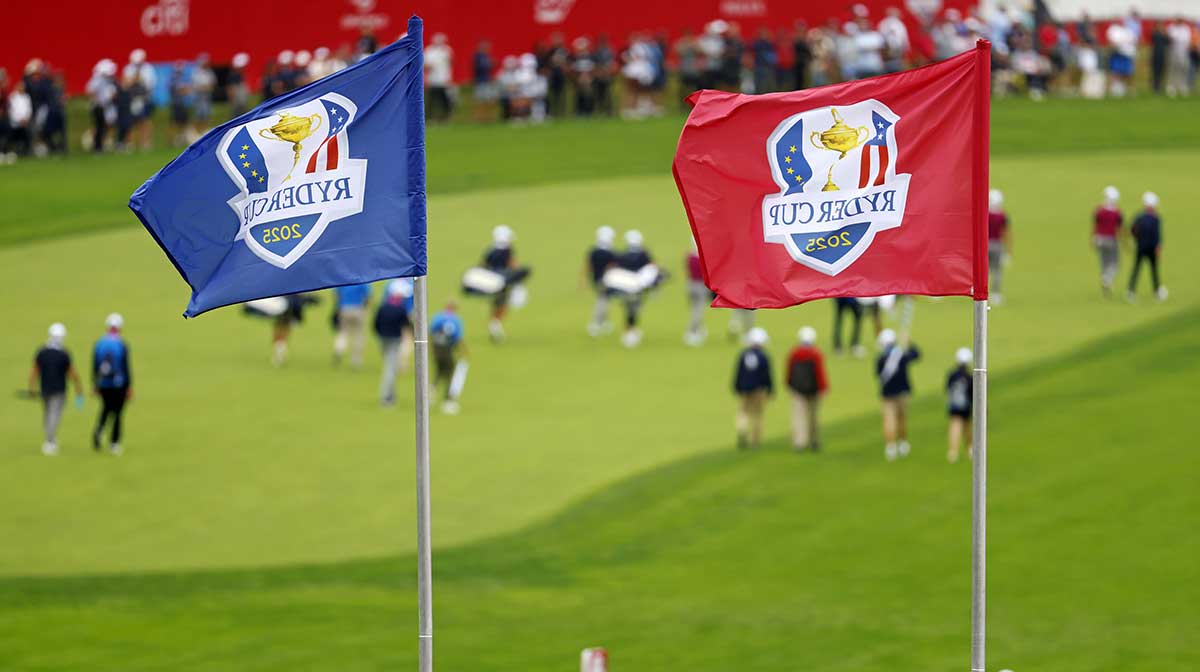 Ryder Cup flags fly over the first hole as Team Europe walks down the fairway during a practice round of the Ryder Cup golf tournament at Bethpage Black.