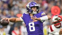 Minnesota Vikings quarterback Sam Howell (8) throws a pass against the New England Patriots during the first quarter at U.S. Bank Stadium.