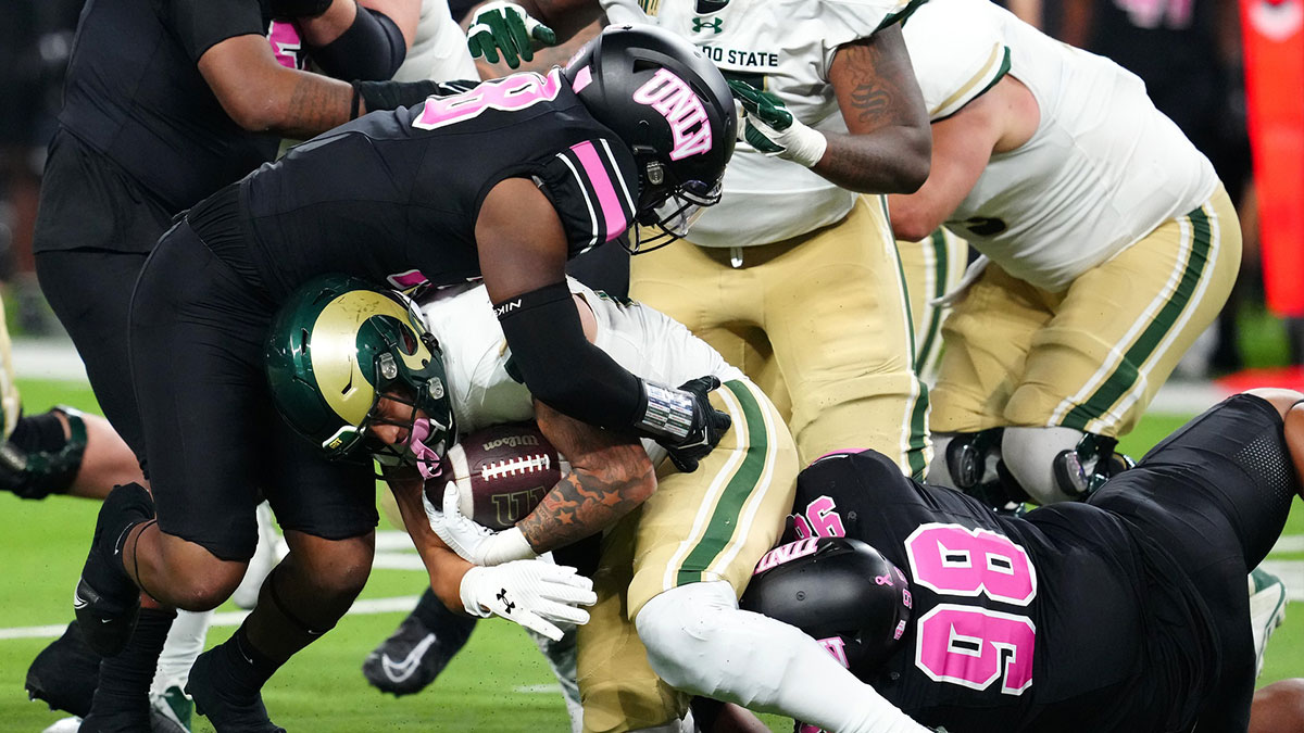 Colorado State Rams running back Avery Morrow (25) is tackled by UNLV Rebels linebacker Marsel McDuffie (38) and UNLV Rebels defensive lineman Tatuo Martinson (98) during the fourth quarter at Allegiant Stadium.