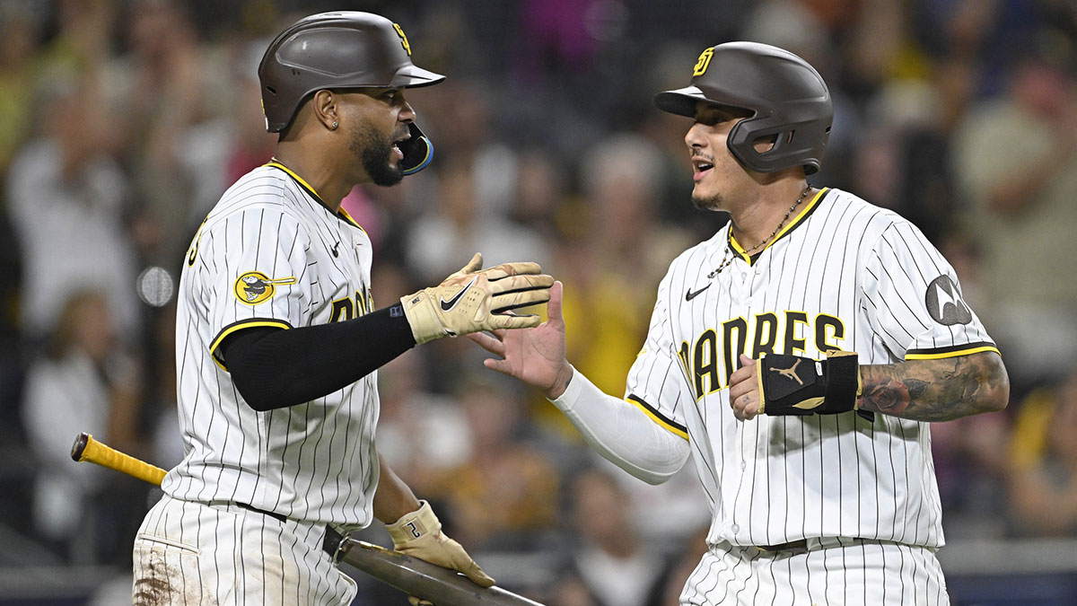 San Diego Padres third baseman Manny Machado (13) is congratulated by Xander Bogaerts (2) after scoring during the fifth inning at Petco Park.