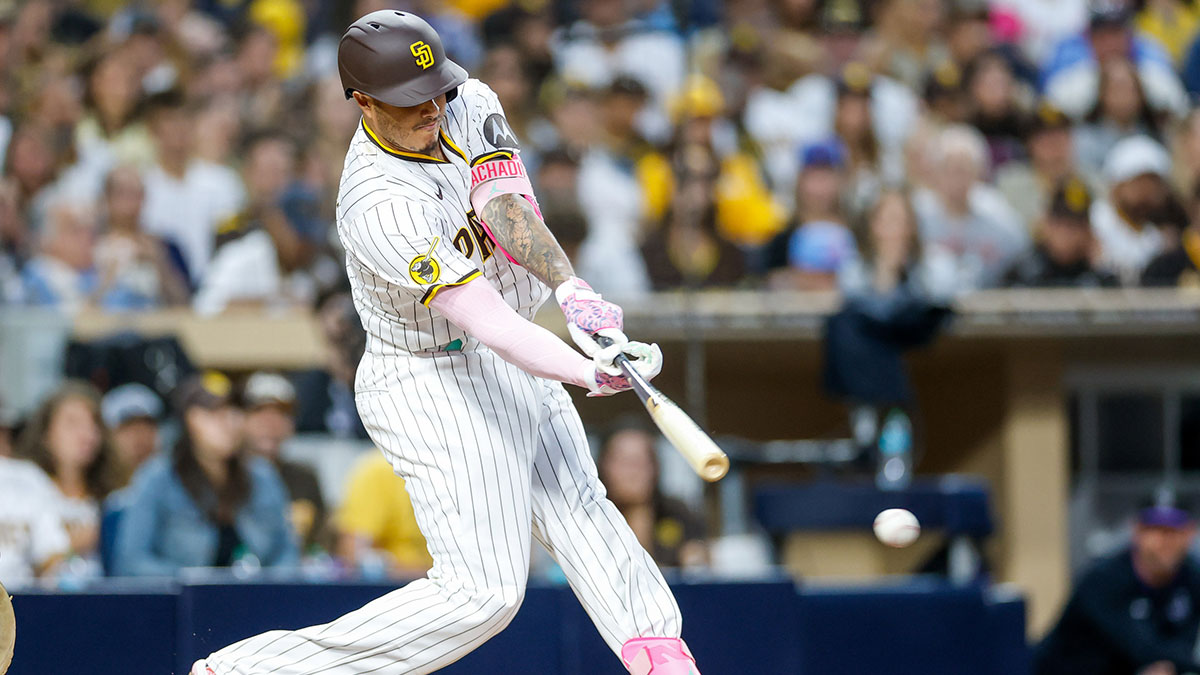 San Diego Padres third baseman Manny Machado (13) hits a two-run single during the fourth inning against the Colorado Rockies at Petco Park.
