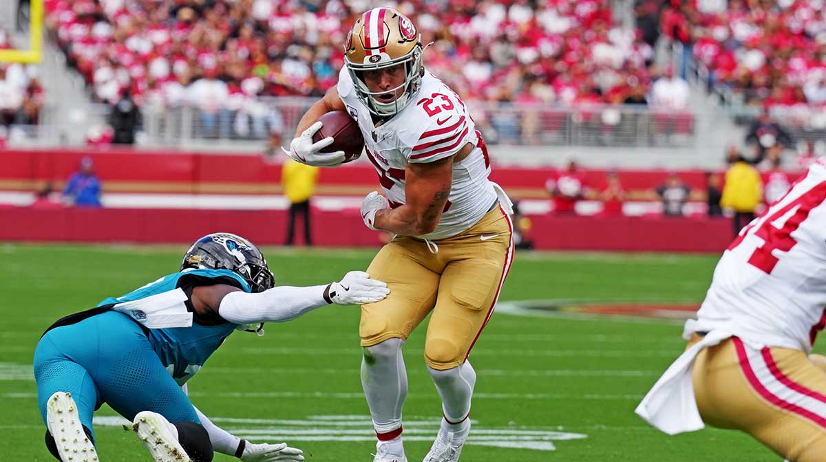 San Francisco 49ers running back Christian McCaffrey (23) escapes a tackle