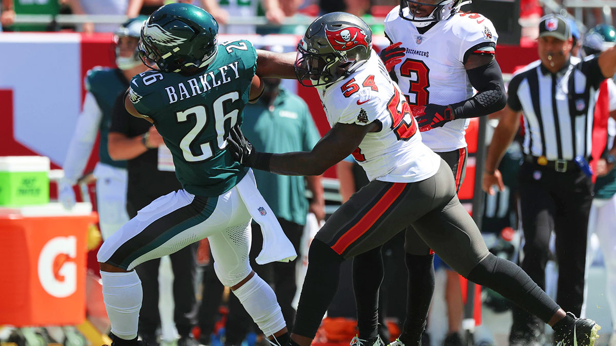 Tampa Bay Buccaneers linebacker Lavonte David (54) tackles Philadelphia Eagles running back Saquon Barkley (26) during the first quarter at Raymond James Stadium.