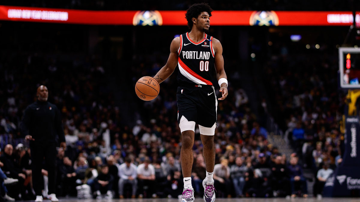 Portland Trail Blazers guard Scoot Henderson (00) dribbles the ball up court in the second quarter against the Denver Nuggets at Ball Arena.