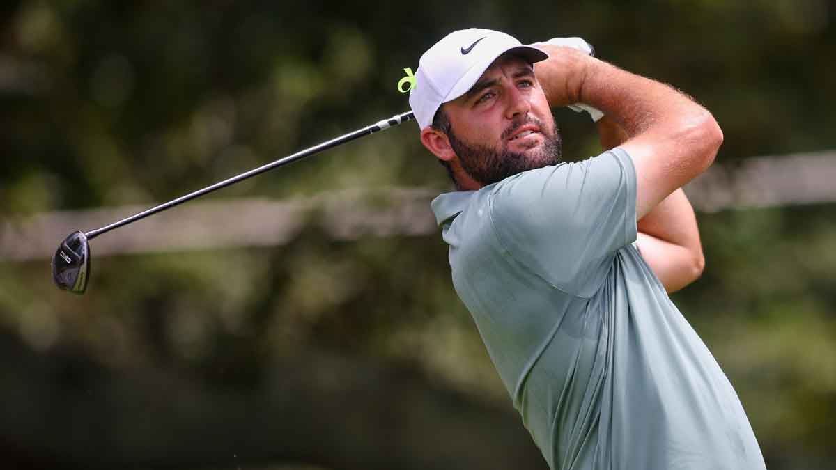 Scottie Scheffler plays his shot from the third tee during the final round of the TOUR Championship golf tournament