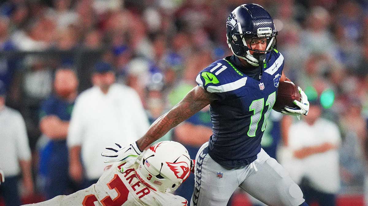 Arizona Cardinals safety Budda Baker (3) dives after Seattle Seahawks receiver Jaxon Smith-Njigba (11) at State Farm Stadium in Glendale on Sept. 25, 2025.