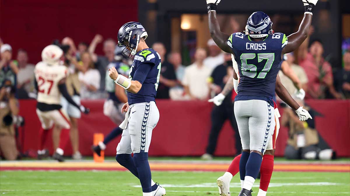 Seattle Seahawks quarterback Sam Darnold (14) and offensive tackle Charles Cross (67) celebrate after a touchdown by tight end AJ Barner (88) in the first quarter against the Arizona Cardinals at State Farm Stadium.