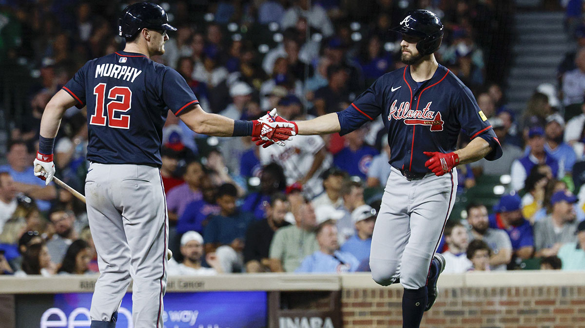 Atlanta Braves left fielder Eli White (36) celebrates with catcher Sean Murphy (12) after hitting a solo home run against the Chicago Cubs during the fifth inning at Wrigley Field.