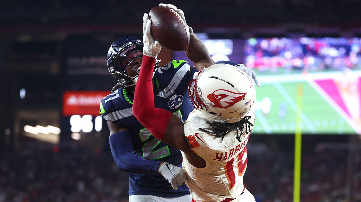 Arizona Cardinals wide receiver Marvin Harrison Jr. (18) makes a catch for a touchdown against Seattle Seahawks cornerback Devon Witherspoon (21) in the fourth quarter at State Farm Stadium.