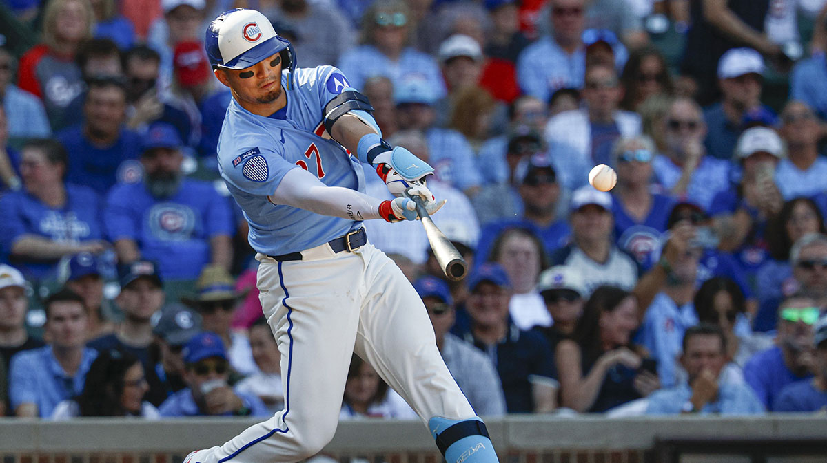 Chicago Cubs right fielder Seiya Suzuki (27) hits a grand slam against the St. Louis Cardinals during the seventh inning at Wrigley Field. 