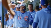 Chicago Cubs designated hitter Seiya Suzuki (27) celebrates with teammates in the dugout after scoring against the Washington Nationals during the first inning at Wrigley Field.