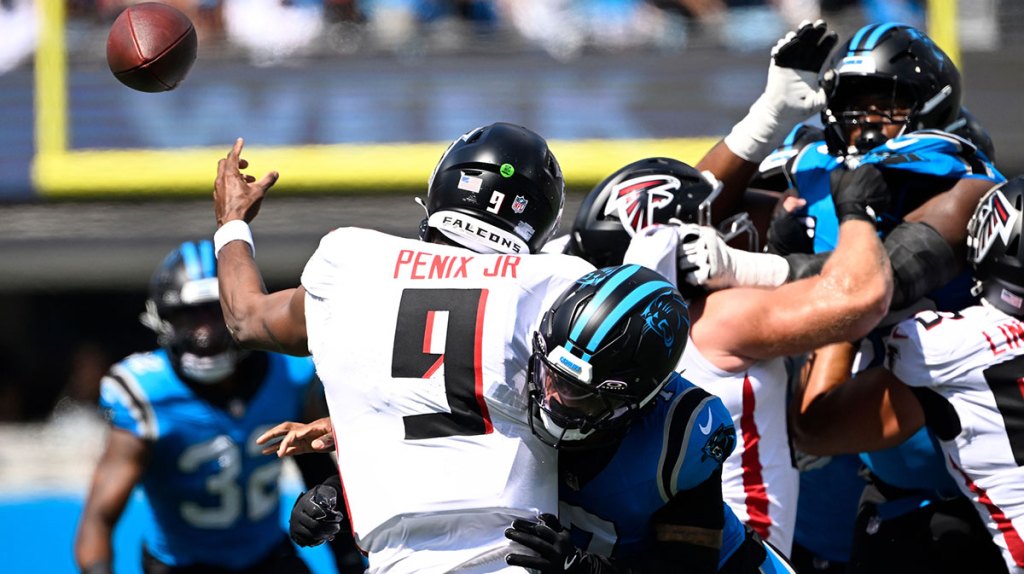 Atlanta Falcons quarterback Michael Penix Jr. (9) is hit as he passes the ball in the first quarter at Bank of America Stadium.