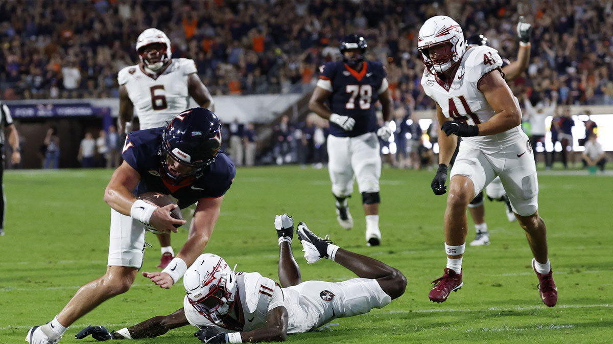 Virginia Cavaliers quarterback Chandler Morris (4) scores a touchdown s Florida State Seminoles defensive back Ja'Bril Rawls (11) defends during the second quarter at Scott Stadium.