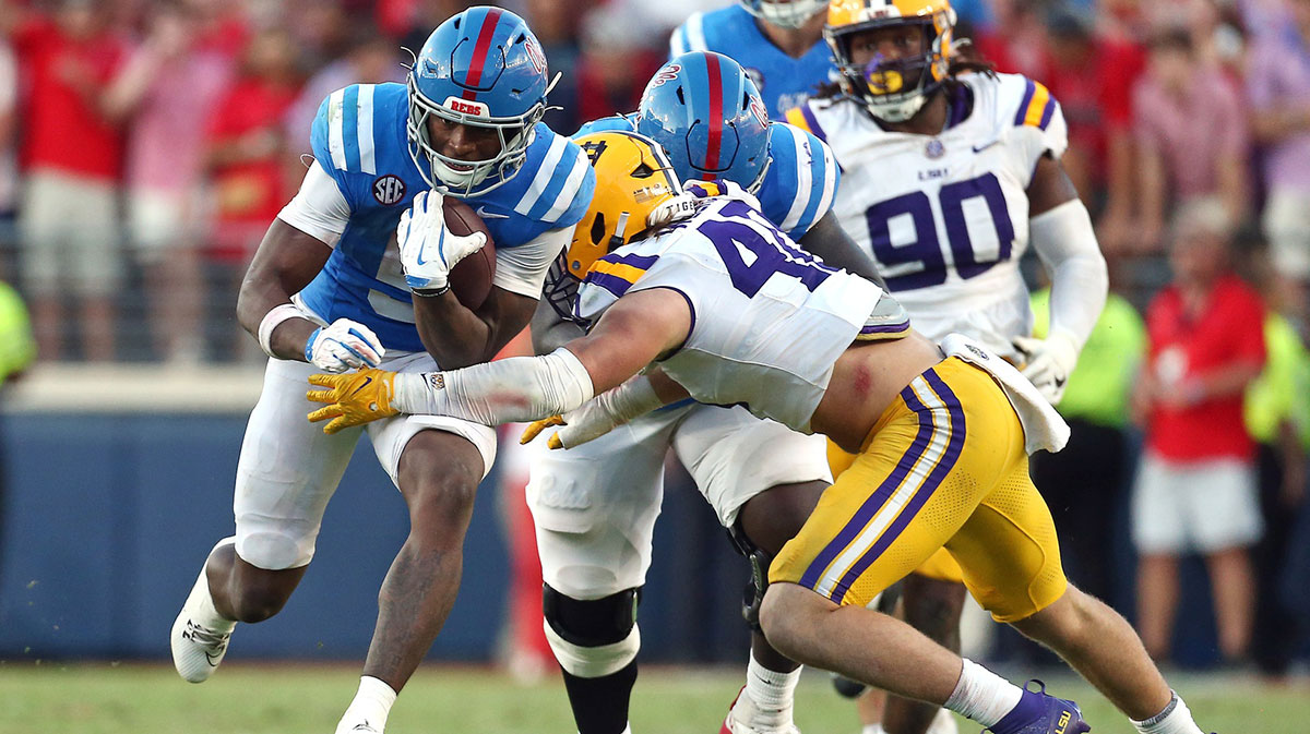Mississippi Rebels running back Kewan Lacy (5) runs the ball as LSU Tigers linebacker Whit Weeks (40) attempts to make the tackle during the fourth quarter at Vaught-Hemingway Stadium.