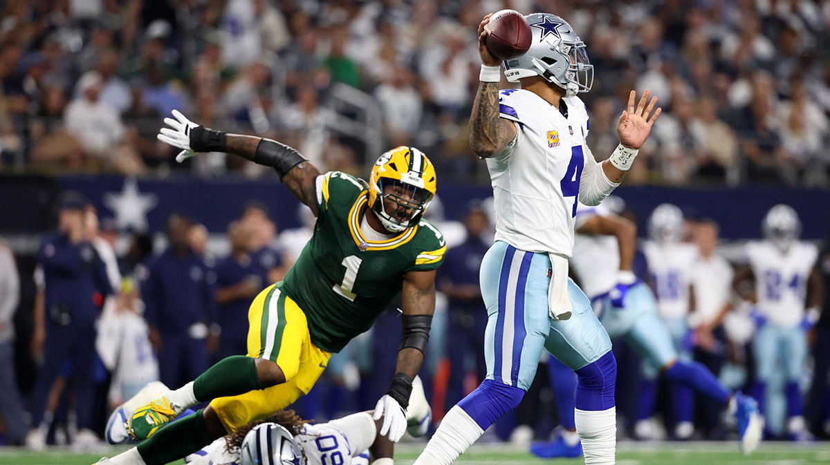 Dallas Cowboys quarterback Dak Prescott (4) throws under pressure from Green Bay Packers defensive end Micah Parsons (1) in the first quarter at AT&T Stadium.