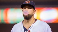 Minnesota Twins first baseman Trevor Plouffe (24) blows a bubble as he walks back to the dugout in the fifth inning against the Kansas City Royals at Target Field.