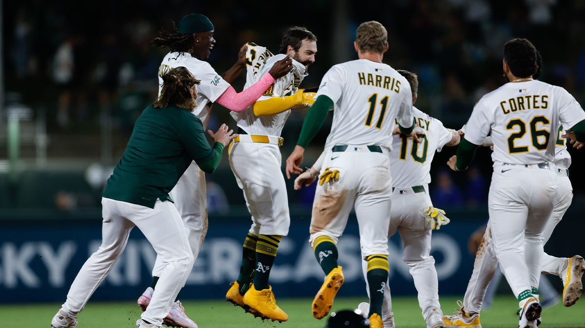 Athletics catcher Shea Langeliers (23) celebrates with teammates after hitting a walk-off RBI double during the ninth inning against the Kansas City Royals at Sutter Health Park.