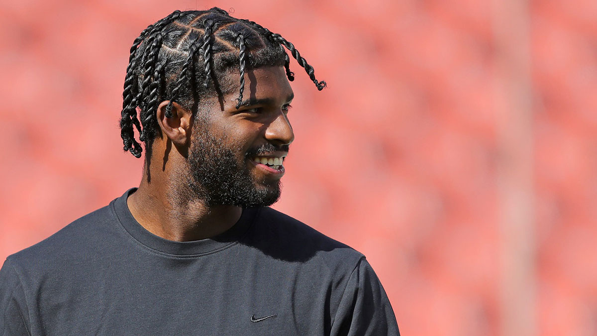 Cleveland Browns quarterback Shedeur Sanders is all smiles as he warms up before an NFL football game at Huntington Bank Field.