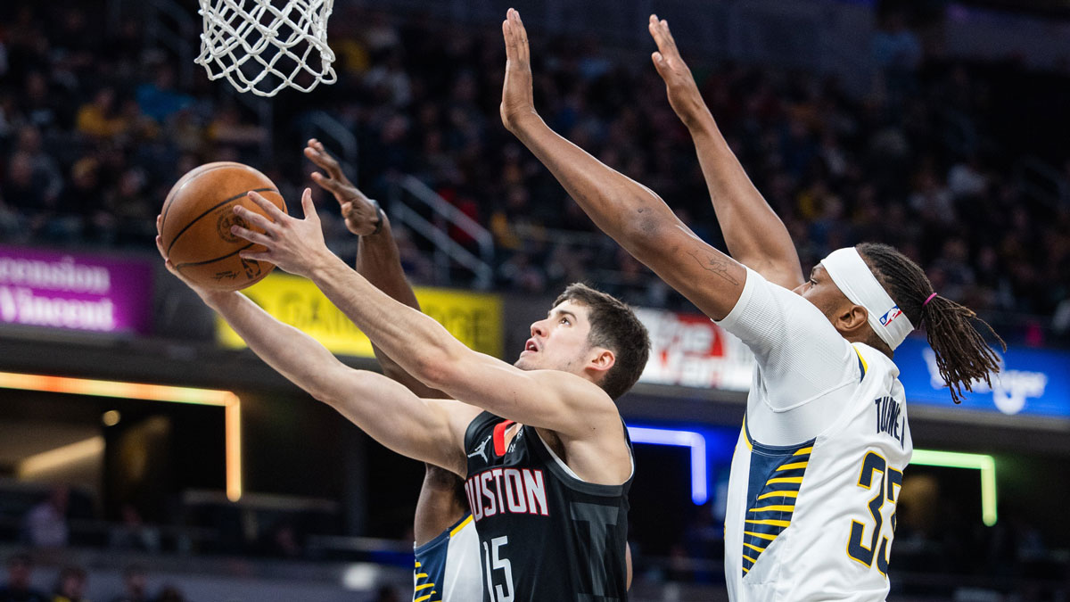 Houston Rockets guard Reed Sheppard (15) shoots the ball while Indiana Pacers center Myles Turner (33) defends in the first half at Gainbridge Fieldhouse