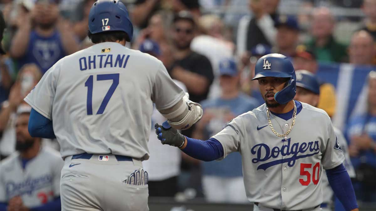 Los Angeles Dodgers shortstop Mookie Betts (50) greets two-way player Shohei Ohtani (17) crossing home plate on a solo home run against the Pittsburgh Pirates during the third inning at PNC Park.
