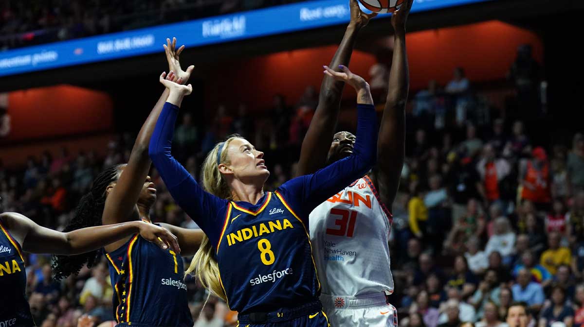 Connecticut Sun center Tina Charles (31) and Indiana Fever guard Sophie Cunningham (8) work for the ball in the first half at Mohegan Sun Arena.