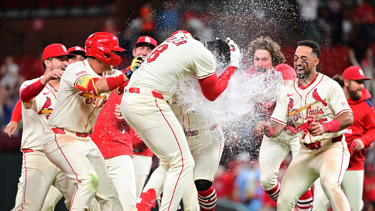 St. Louis Cardinals teammates douse St. Louis Cardinals outfielder Jordan Walker (18, center) with water as they celebrate their 3-2 win over the San Francisco Giants after Walker doubled to left, scoring shortstop Masyn Winn and second baseman Garrett Hampson in the bottom of the ninth inning at Busch Stadium.