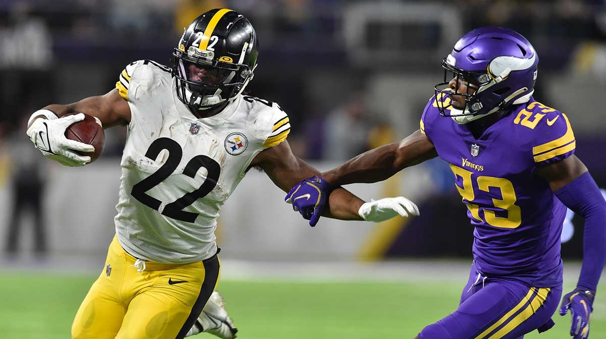 Pittsburgh Steelers running back Najee Harris (22) runs with the ball as Minnesota Vikings free safety Xavier Woods (23) chases during the third quarter at U.S. Bank Stadium.
