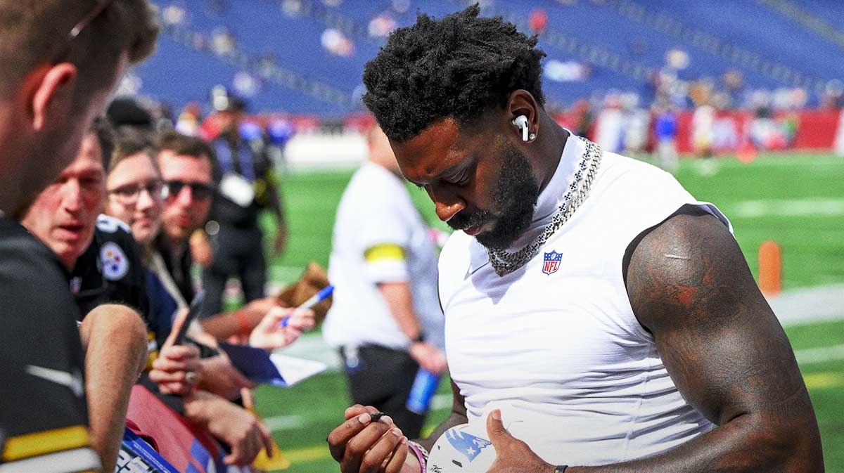 Pittsburgh Steelers linebacker Patrick Queen (6) signs a football before the game against New England Patriots at Gillette Stadium.