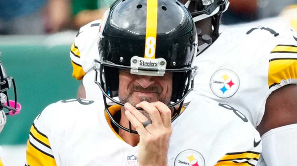 Pittsburgh Steelers quarterback Aaron Rodgers (8) gets his bearings after being sacked in the fourth quarter, Sunday, September 7, 2025, in East Rutherford.