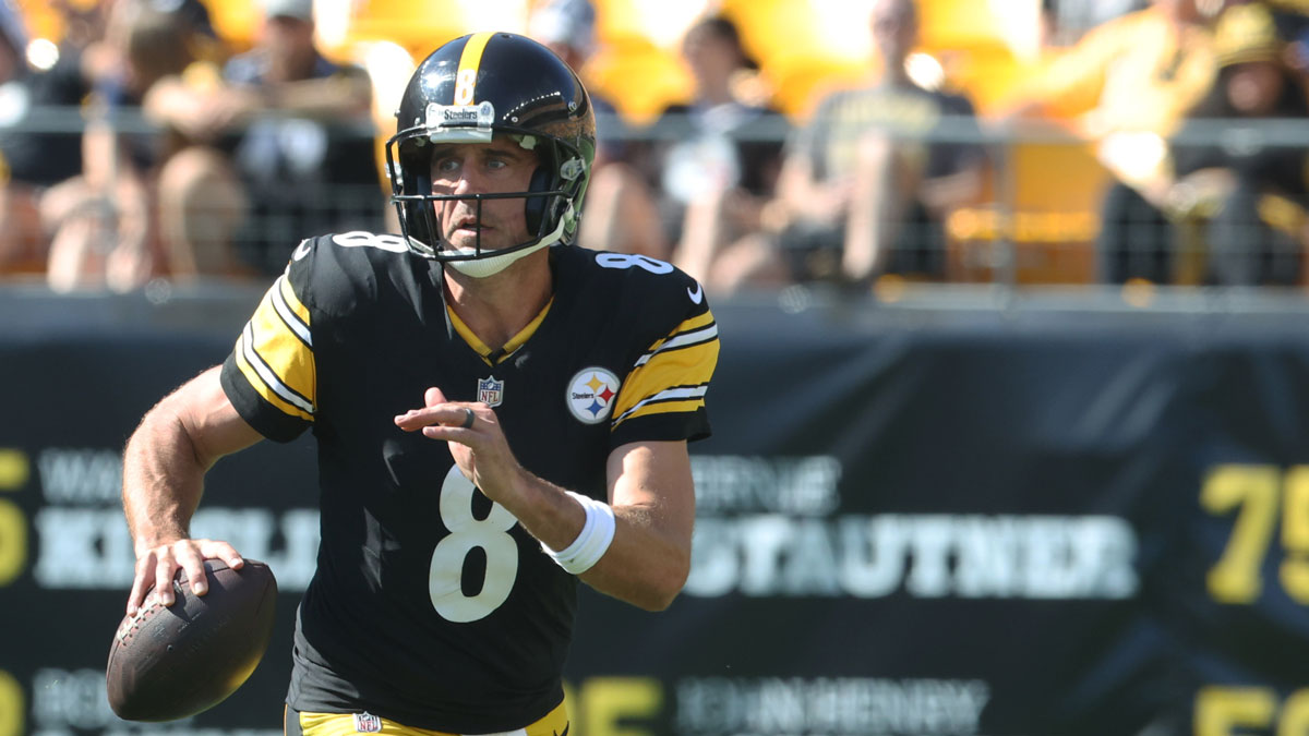 Steelers quarterback Aaron Rodgers (8) scrambles with the ball against the Seattle Seahawks during the fourth quarter at Acrisure Stadium