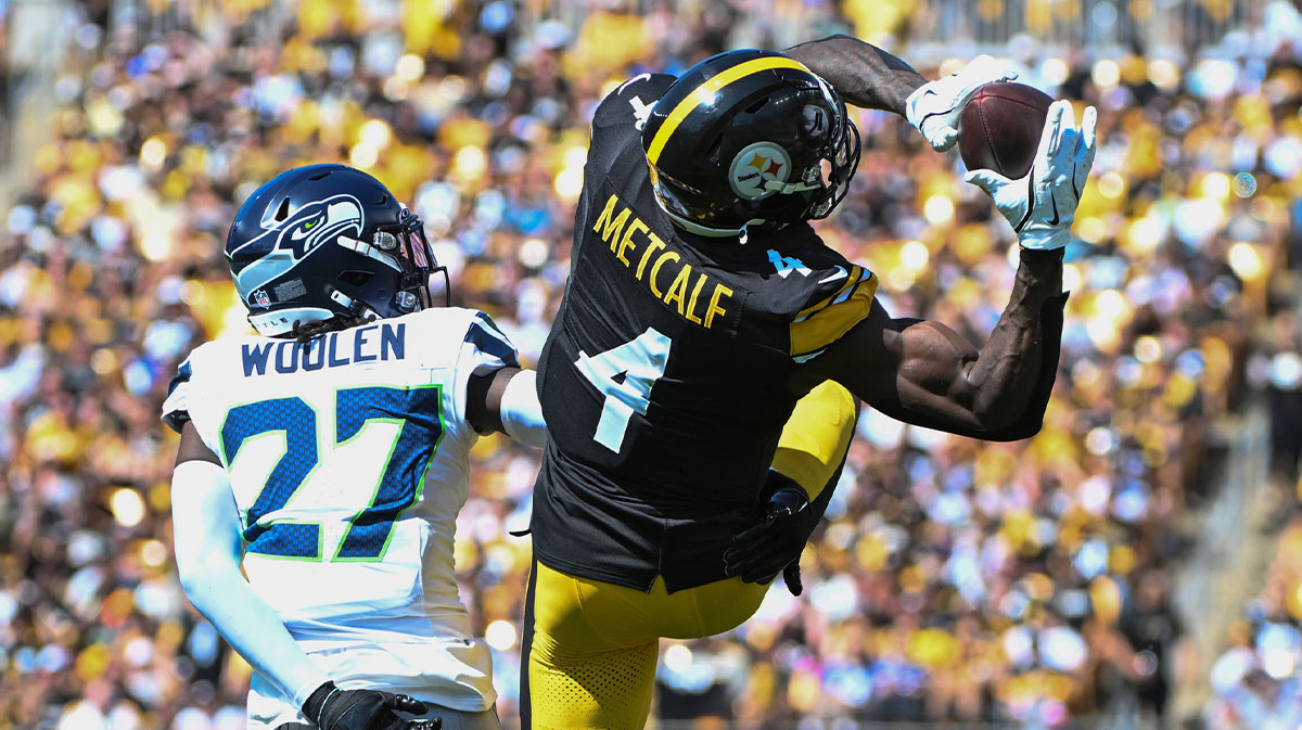 Pittsburgh Steelers wide receiver DK Metcalf (4) catches a pass over Seattle Seahawks cornerback Riq Woolen (27) during the second quarter at Acrisure Stadium.