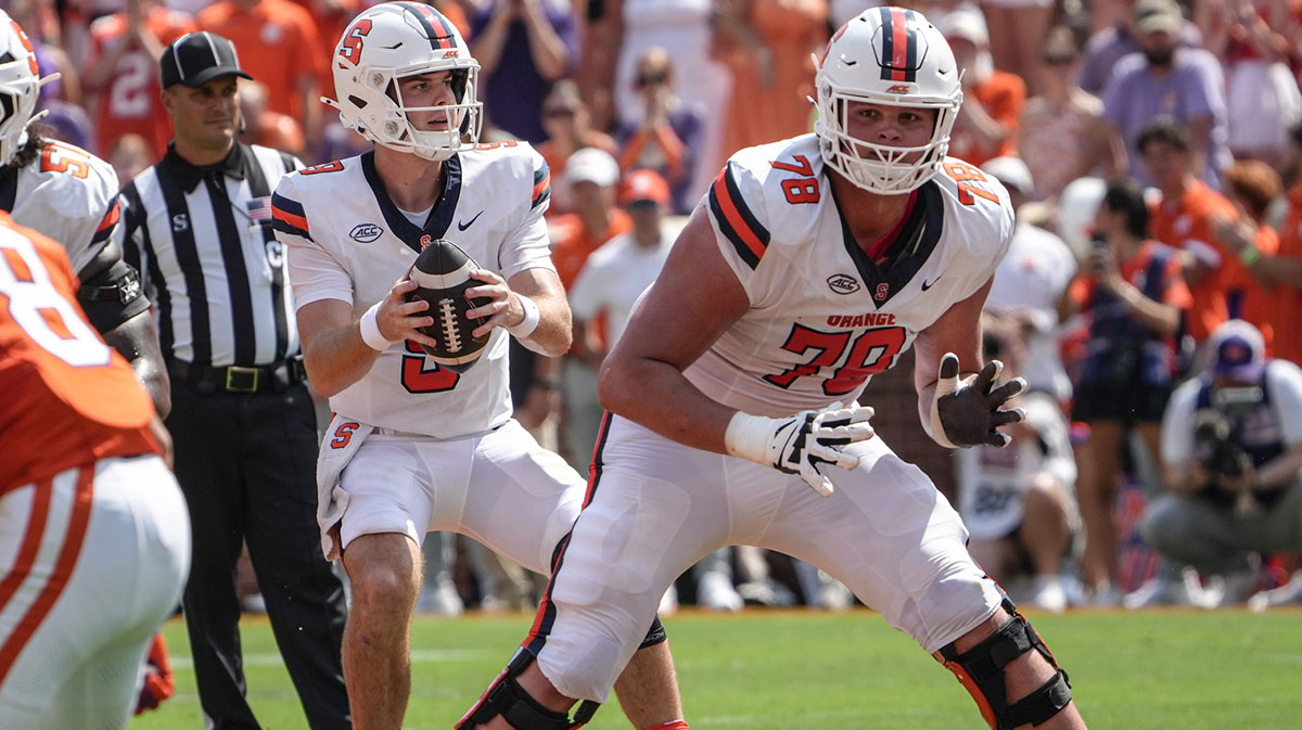 Syracuse Orange quarterback Steve Angeli (9) takes a snap near offensive lineman Joe Cruz (78) playing the Clemson Tigers during the first quarter at Memorial Stadium.