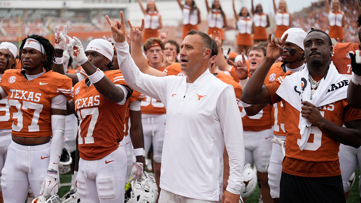 Texas Longhorns head coach Steve Sarkisian and players hold up their horns with the fans during the singing of the Eyes of Texas after a victory over the San Jose State Spartans at Darrell K Royal-Texas Memorial Stadium.