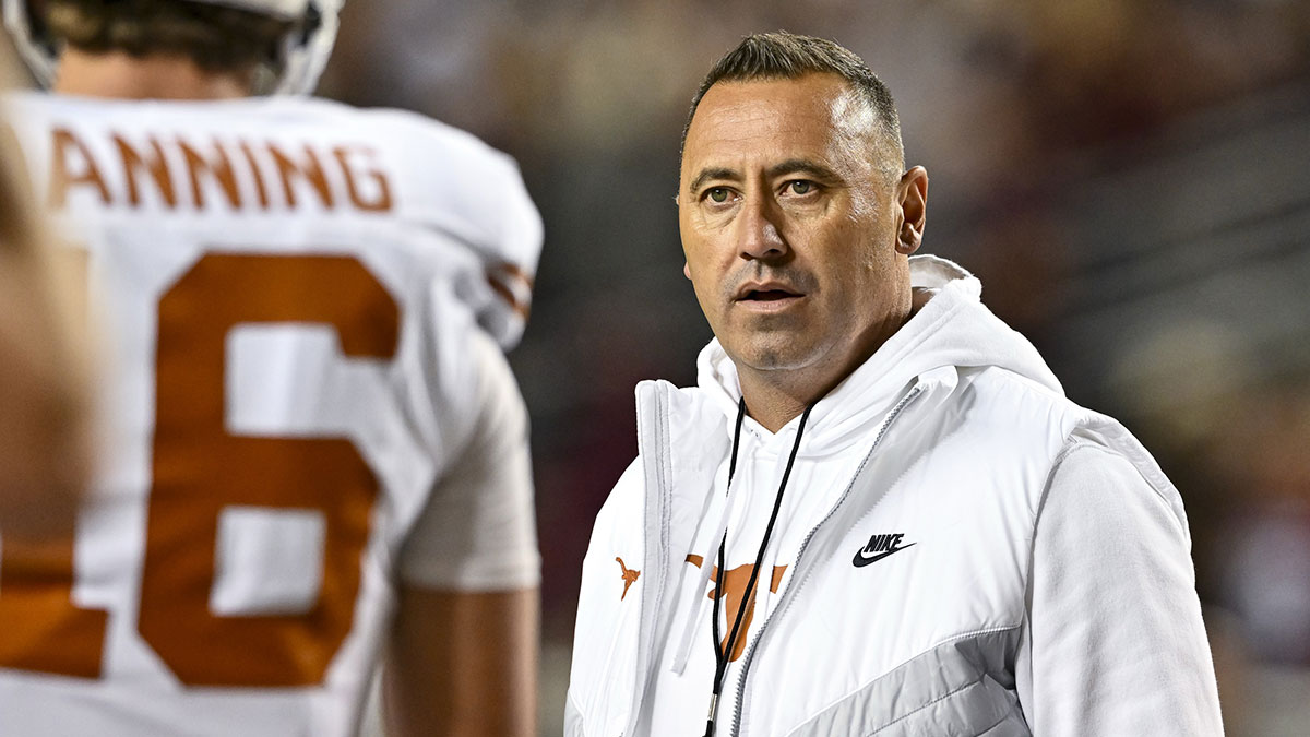 Texas Longhorns head coach Steve Sarkisian speaks with quarterback Arch Manning (16) during warm ups against the Texas A&M Aggies at Kyle Field.