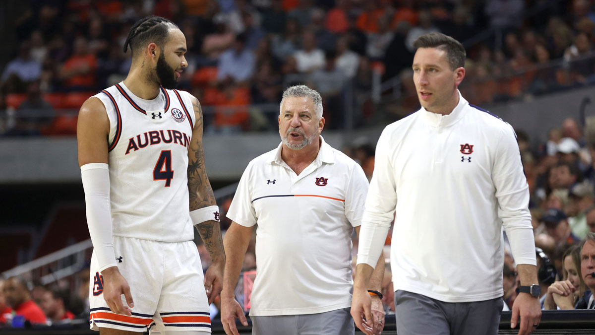 Auburn Tigers center Johni Broome (4) talks with head coach Bruce Pearl and assistant coach Steven Pearl during the second half against the Mississippi Rebels at Neville Arena. 