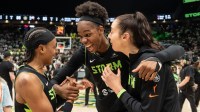 Seattle Storm, from left, guard Brittney Sykes (20), center Dominique Malonga (14) and forward Katie Lou Samuelson (33) celebrate game two of round one for the 2025 WNBA Playoffs against the Las Vegas Aces at Climate Pledge Arena.