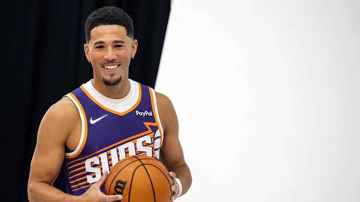 Suns guard Devin Booker (1) poses for portrait during Media Day at PHX Arena with Kendrick Perkins in the background