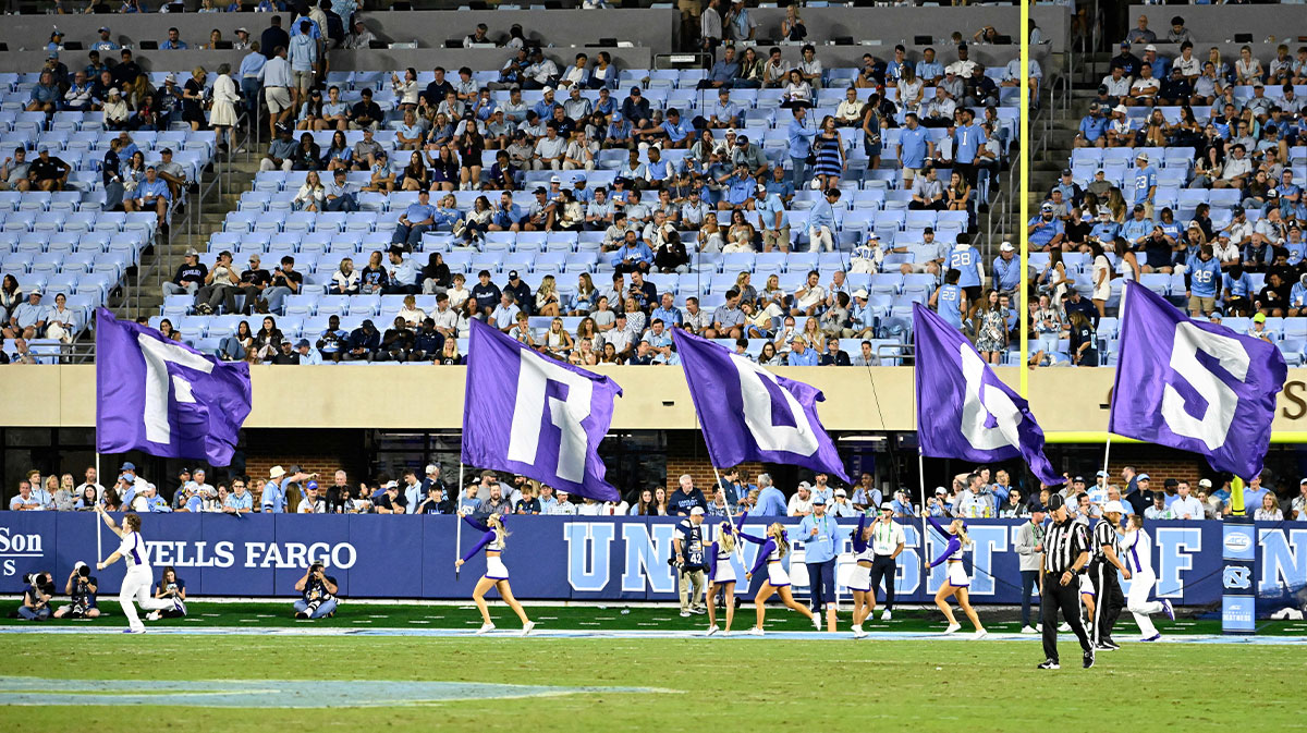 TCU Horned Frogs cheerleaders celebrate with flags after a touchdown in the third quarter at Kenan Stadium.
