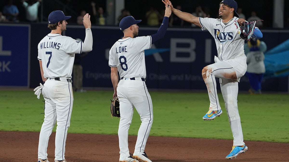 Tampa Bay Rays shortstop Carson Williams (7) (left), second base Brandon Lowe (8) (middle), and outfielder Christopher Morel (24) (right) celebrate after defeating the Boston Red Sox at George M. Steinbrenner Field.
