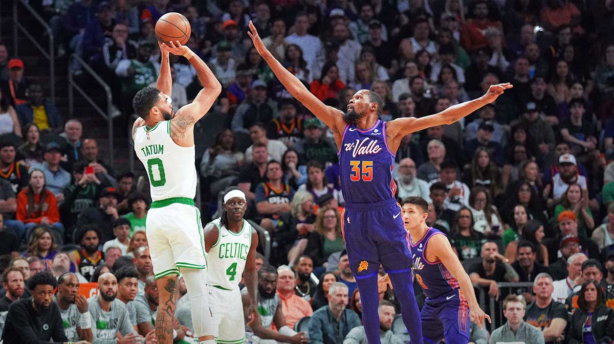 Boston Celtics forward Jayson Tatum (0) shoots over Phoenix Suns forward Kevin Durant (35) during the first half at Footprint Center.