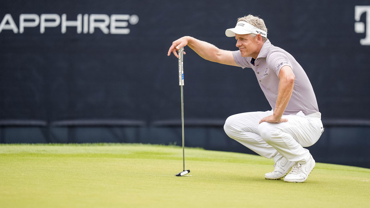 Luke Donald looks over his line on the green at the second hole during the second round of the PGA Championship golf tournament at Quail Hollow.