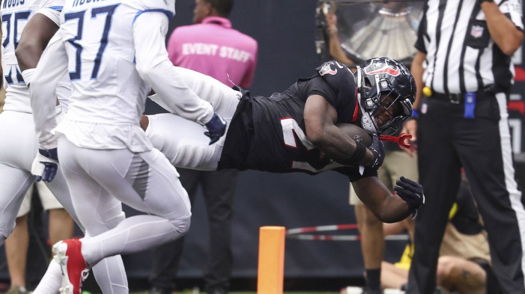 Houston Texans running back Woody Marks (27) dives into the end zone for a touchdown during the fourth quarter against the Tennessee Titans at NRG Stadium.