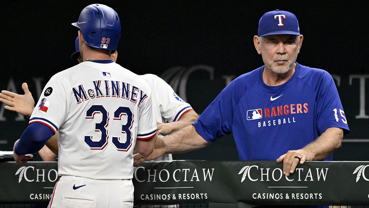 Texas Rangers manager Bruce Bochy (15) greets right fielder Billy McKinney (33) in the dugout during the seventh inning at Globe Life Field.