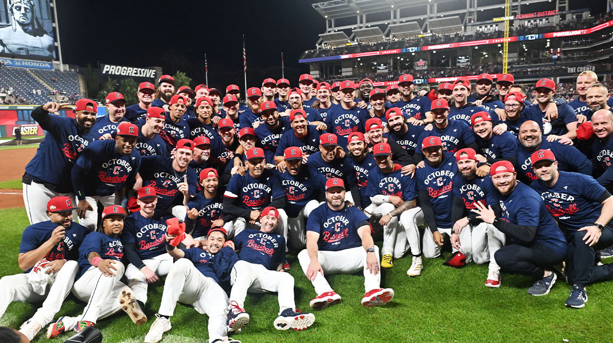 The Cleveland Guardians pose for a photo after they beat the Texas Rangers to secure a playoff berth at Progressive Field.