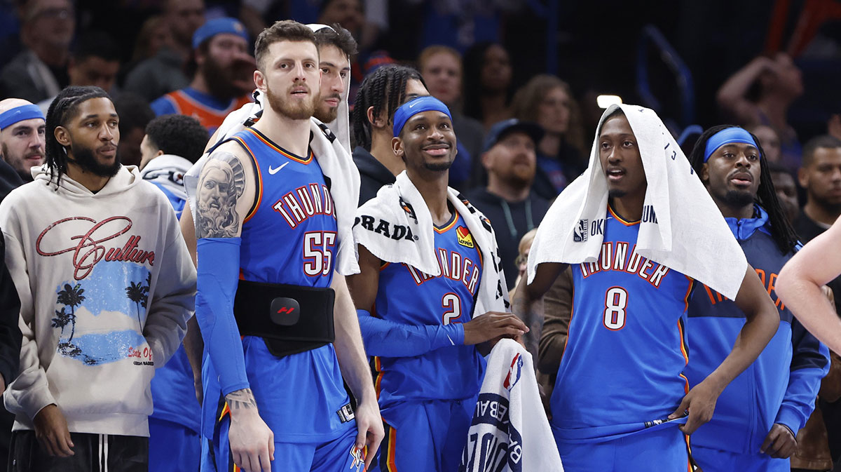 Thunder guard Isaiah Joe (11), center Isaiah Hartenstein (55), forward Chet Holmgren (7), guard Shai Gilgeous-Alexander (2), forward Jalen Williams (8) and guard Luguentz Dort (5) watch the end of a game against the New Orleans Pelicans at Paycom Center