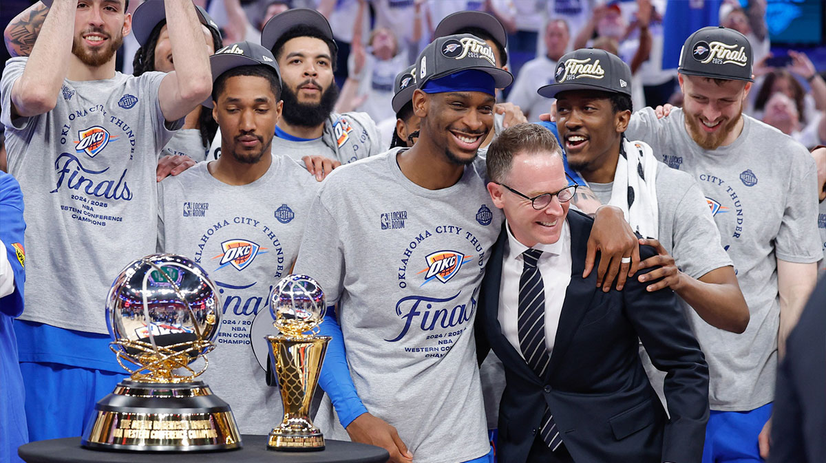 Thunder guard Shai Gilgeous-Alexander hugs Oklahoma City Thunder executive vice president and general manager Sam Presti after their team defeated the Minnesota Timberwolves in game five of the western conference finals for the 2025 NBA Playoffs at Paycom Center with Thunder extensions to Shai Gilgeous-Alexander, Jalen Williams, and Chet Holmgren in the background