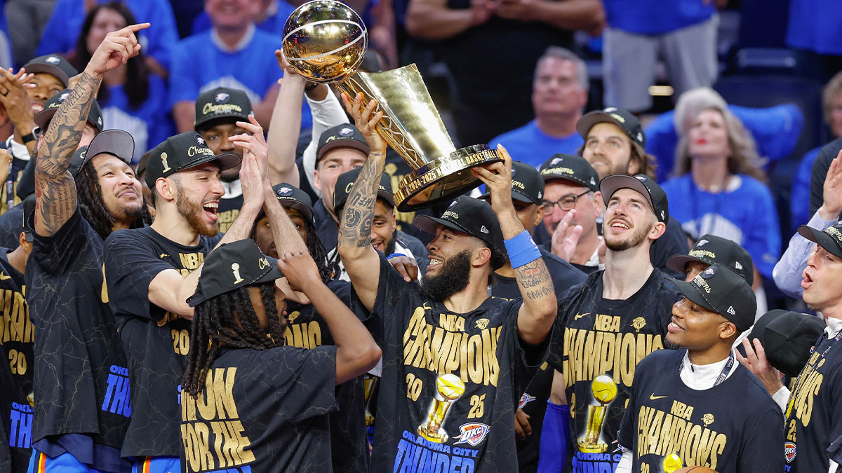 Thunder forward Kenrich Williams (34) holds up the NBA Finals Larry O'Brien Championship Trophy after his team defeated the Indiana Pacers in game seven of the 2025 NBA Finals at Paycom Center