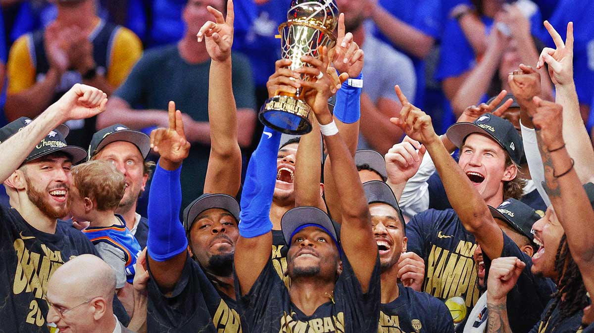 Thunder guard Shai Gilgeous-Alexander (2) holds up his NBA Finals Bill Russell MVP trophy at the end of game seven of the 2025 NBA Finals after defeating the Indiana Pacers at Paycom Center with Thunder Sam Presti in the background